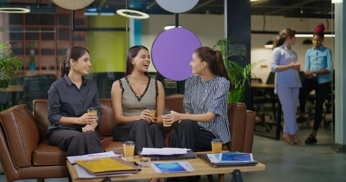 gen z employees talking on a couch