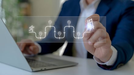 man researching employee benefits at computer maps a pathway