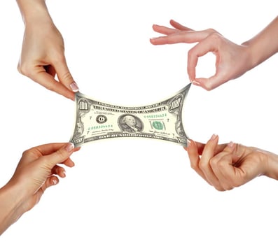 hands stretch a dollar bill demonstrating how the best employee discount programs help employees stretch their paychecks