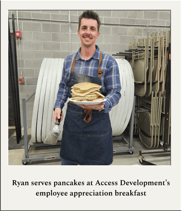 Ryan serves pancakes at Access Developments employee appreciation breakfast