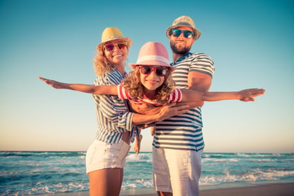family beach vacation travel with their employee travel benefits
