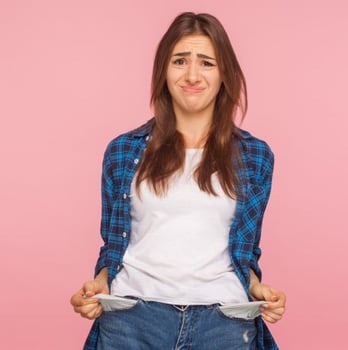 woman turns out empty pockets showing her financial insecurity and need for employee discounts