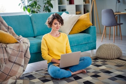 woman sitting on a laptop researching employee benefits